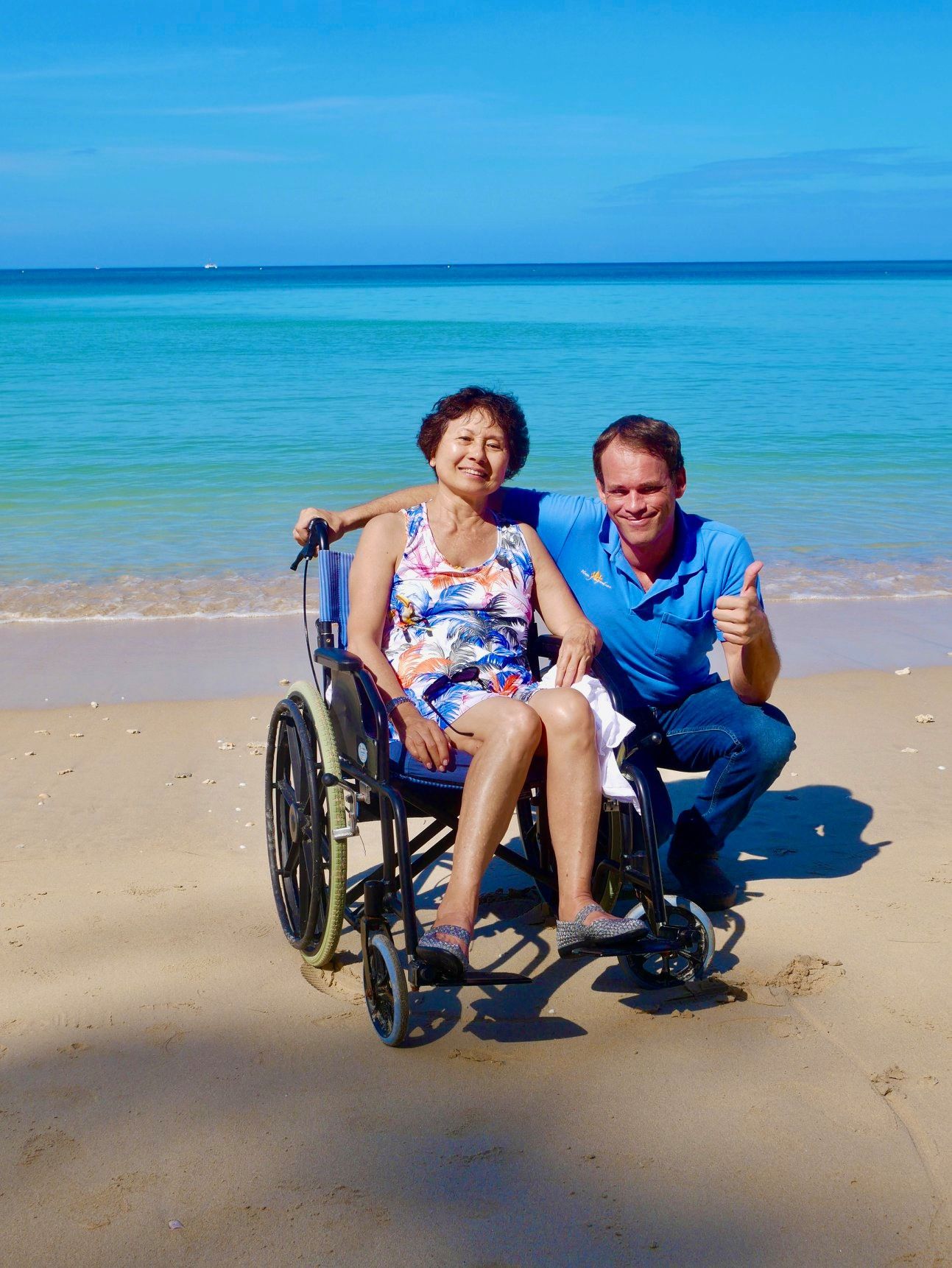 Rollstuhlfahrerin am Strand Nai Harn