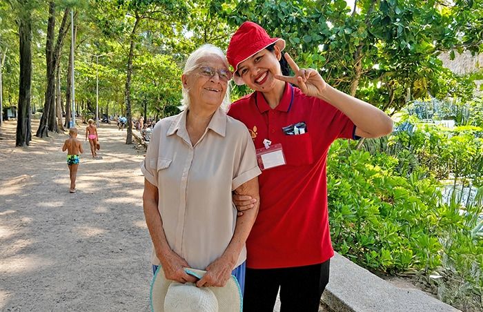 Carewell caregiver sharing a cheerful moment with a resident outdoors